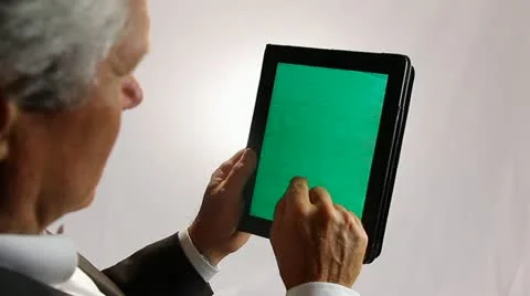 BUSINESSMAN WORKS ON A GREENSCREEN TABLET COMPUTER Stock Footage 12159715