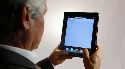 BUSINESSMAN WORKS ON A TABLET COMPUTER Stock Footage 12155041