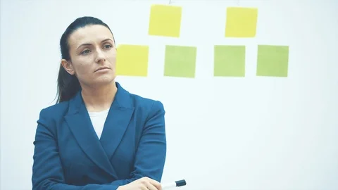 A businessman write on glue notes on a glass wall in the workplace. Adhesive Stock Footage 117383113