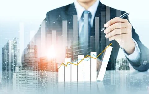 Businessman write increasing graph with city background, business growth Stock Photos