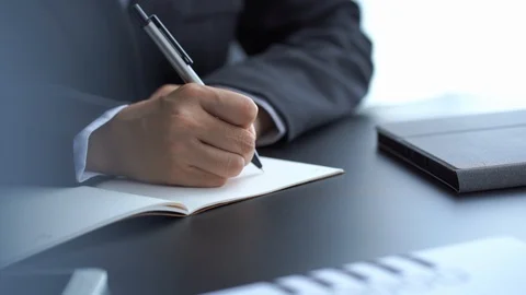 Businessman write on notebook on desk in office Stock Footage 121191475