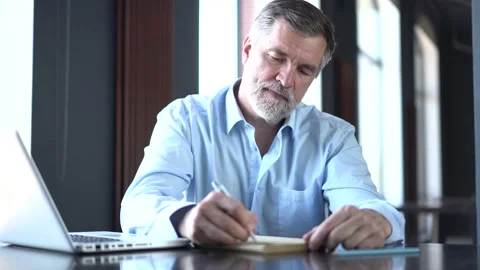 Businessman write on notebook on desk in office, planning concept Stock Footage 132921046