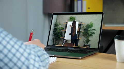 Businessman writes in notebook, study watch business online course laptop webcam Stock Footage 150956361