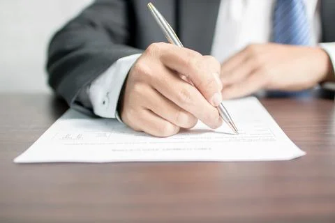 Businessman writing on application form 库存照片