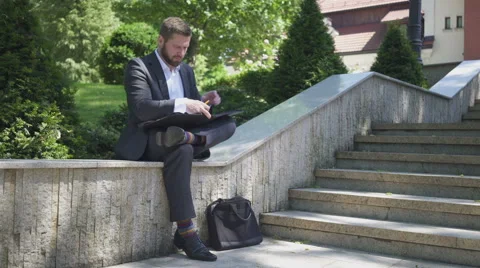 Businessman is writing down data from smartphone to documents. Vídeo Stock 52772600