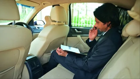 Businessman writing in notebook inside a car Stock Footage 277036235