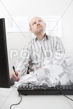 Businessman Writing With Rejected Papers On Keyboard Stock Photos