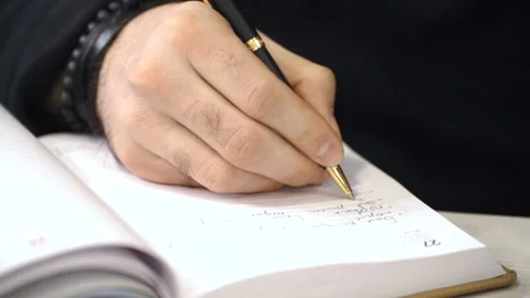 Businessman is writing something in planner Video stock 86399811