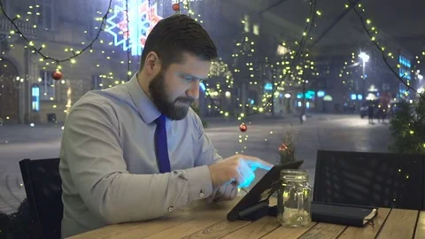Businessman writing on tablet computer, evening, cafe, christmas time 動画素材 72999068