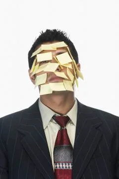 Businessman's face wrapped with adhesive notes Stock Photos