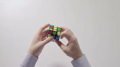 Businessman's hands solving rubik's cube puzzle. Part 05. Recycled video. Stock Footage 94203386