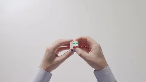 Businessman's hands solving rubik's cube puzzle toy. Part 03. Recycled video. Stock Footage 94204810