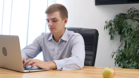 Businessman's hands type at desktop keyboard in workspace. Blurred background Stock Footage 124658979