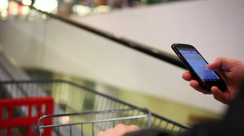 Businessmans hands using phone in the shopping mall until go escalator with Stock Footage 47478139