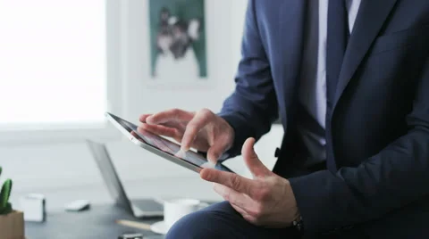 Businessman's hands visible while he uses a tablet. Stock Footage 68395330