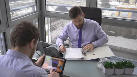 Businessmen, analyzing data on laptop, tablet, computer, documents, office 库存影片 73224940