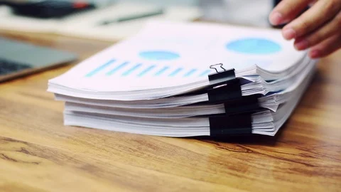 Businessmen are searching for documents lying on the table,business report pa Stock Footage 93026367