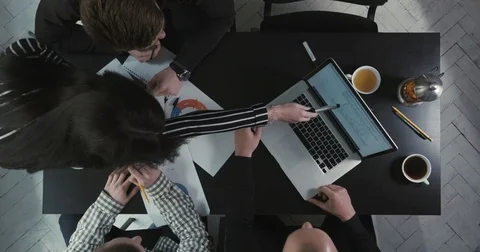 The businessmen are solving the business issues using graphics and laptop. The Stock Footage 76442796