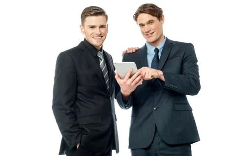 Businessmen browsing on tablet device Stock Photos