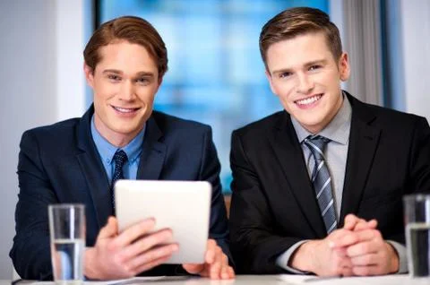 Businessmen browsing on tablet device Stock Photos