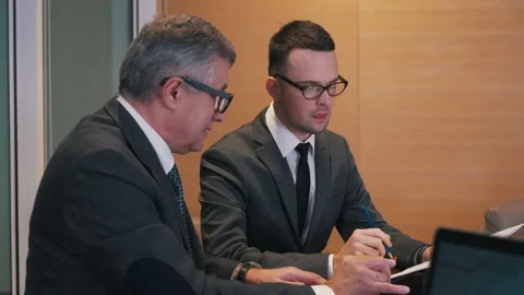Businessmen discussing data in the office Stock Footage 150232140