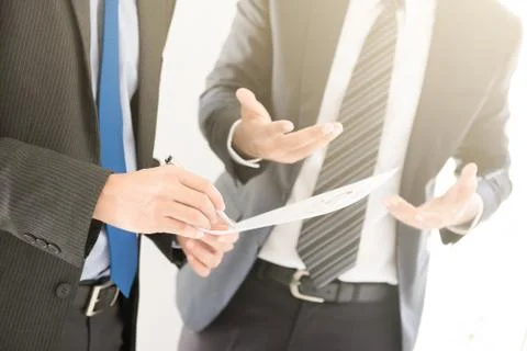 Businessmen discussing document Stock Photos