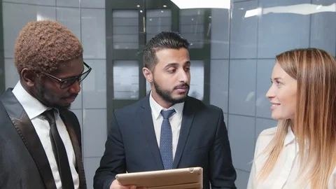 Businessmen in elevator with tablet computer Stock Footage 100962663