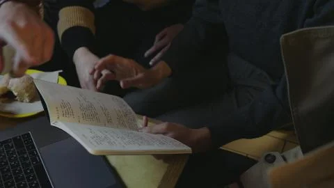 Businessmen hands checking notes in notebook. Freelancers having working meeting Stock Photos