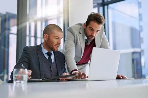 Businessmen, laptop and problem solving for teamwork in office, accounting Foto stock