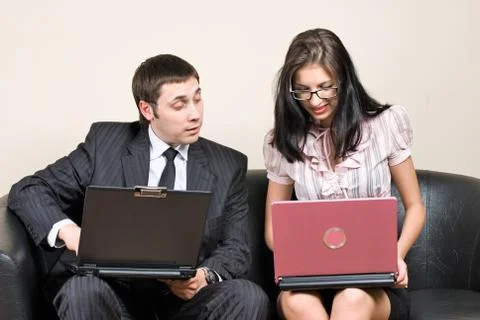 Businessmen with laptops on sofa Stock Photos