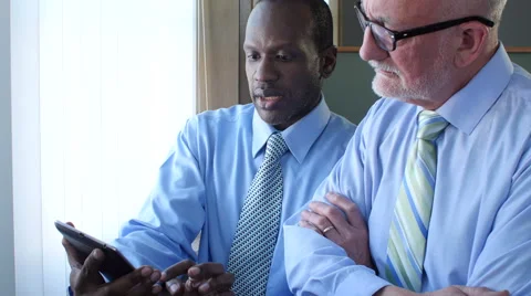 Businessmen looking at tablet Stock Footage 48330378