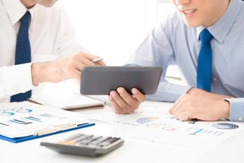 Businessmen looking at tablet pc screen,  analyzing financial data Stock Photos