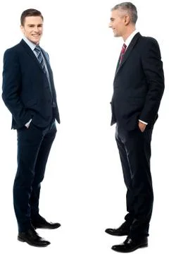 Businessmen posing with hands in pockets Stock Photos