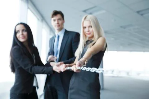 Businessmen pulling chain Stock Photos