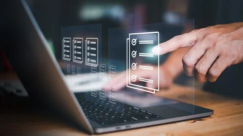 Businessmen review procedures through documents containing checkbox lists, .. Stock Photos