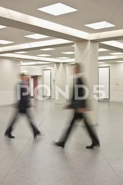Businessmen rushing past each other Stock Photos