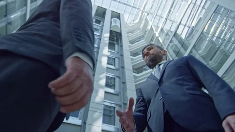 Businessmen Shaking Hands in Business Centre Stock Footage