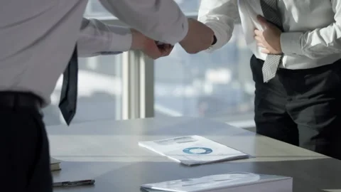 Businessmen Shaking Hands Over Documents on Office Desk Stock-Footage 337876534