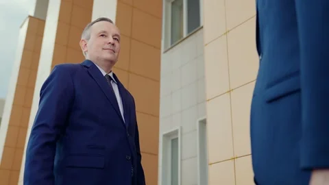 Businessmen shaking hands, teamwork. Two men shaking hands, making successful Stock Footage 252587912