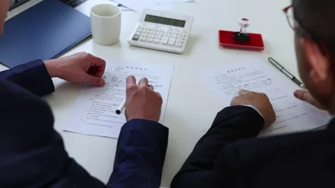 Businessmen sign the contract documents of both parties and shake hands with Stock Footage 240154704