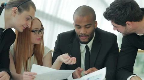 Businessmen sitting at table in office while discussing their of business doings Stock Footage 43492393