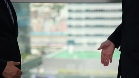 Businessmen in suits shake hands Stock Footage 144902655