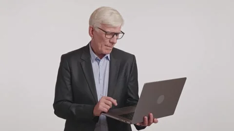 Businessmen in suits using laptops, showcasing technology across generations Stock Footage 266921926