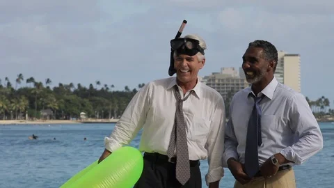 Businessmen talking on a beach with an inflatable. 스톡 동영상 88369362