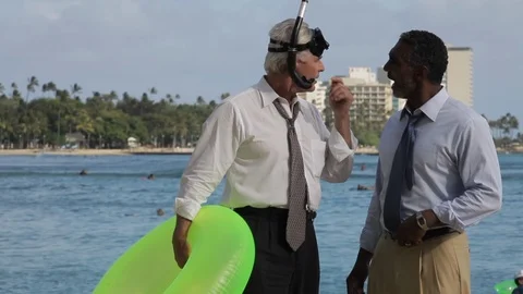 Businessmen talking on a beach with an inflatable. 스톡 동영상 88369364