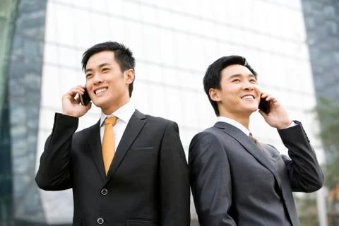 Businessmen talking on cellphone Foto stock