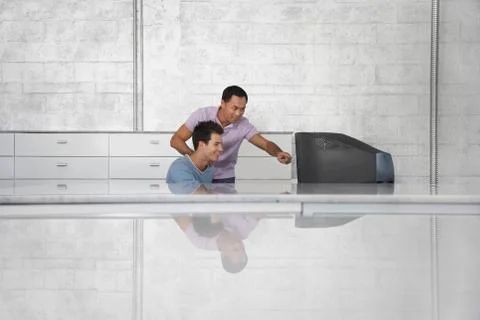 Businessmen Using Computer At Reception Desk Stockfoto's
