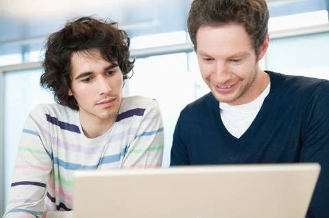 Businessmen using a laptop in an office Stock Photos