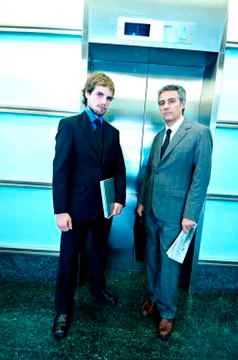 Businessmen waiting for elevator, portrait Stock Photos