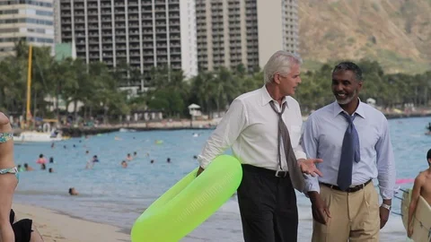 Businessmen walking on a beach with an inflatable. Stock-Footage 88369306